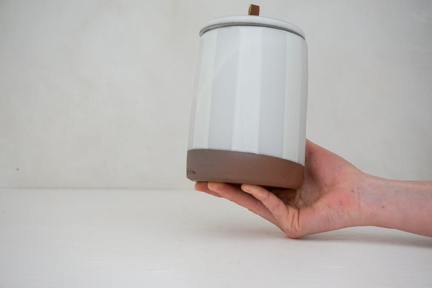 Glossy white glaze stripes on flat white slip Tall jar image 0