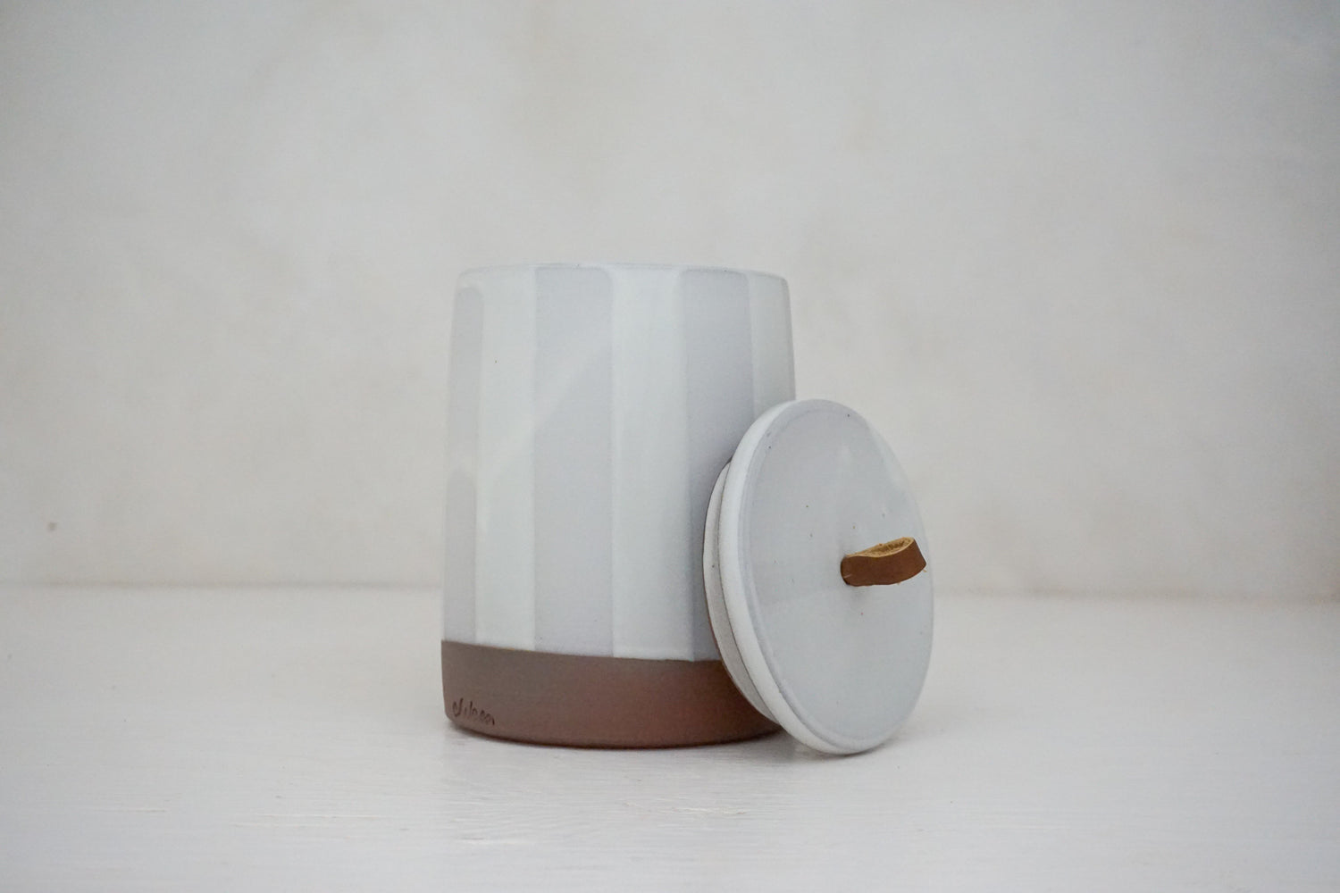 Glossy white glaze stripes on flat white slip Tall jar image 3