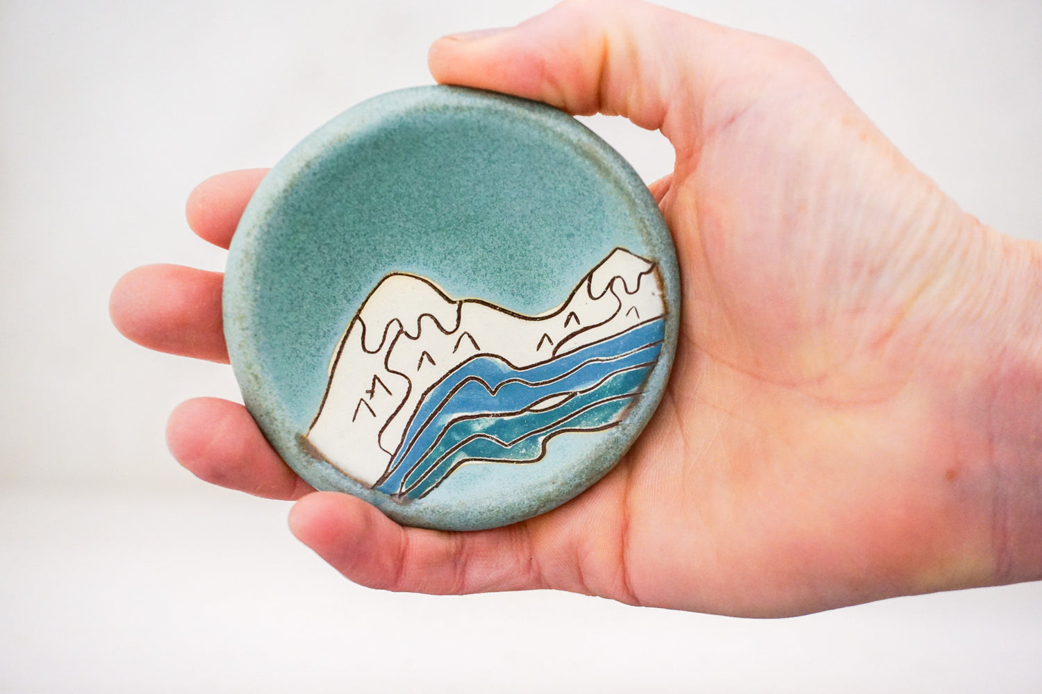 Snow caps ring dish in Lake