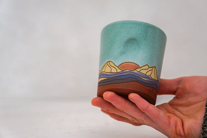 Orange Sunrise Mountain cup In Lake