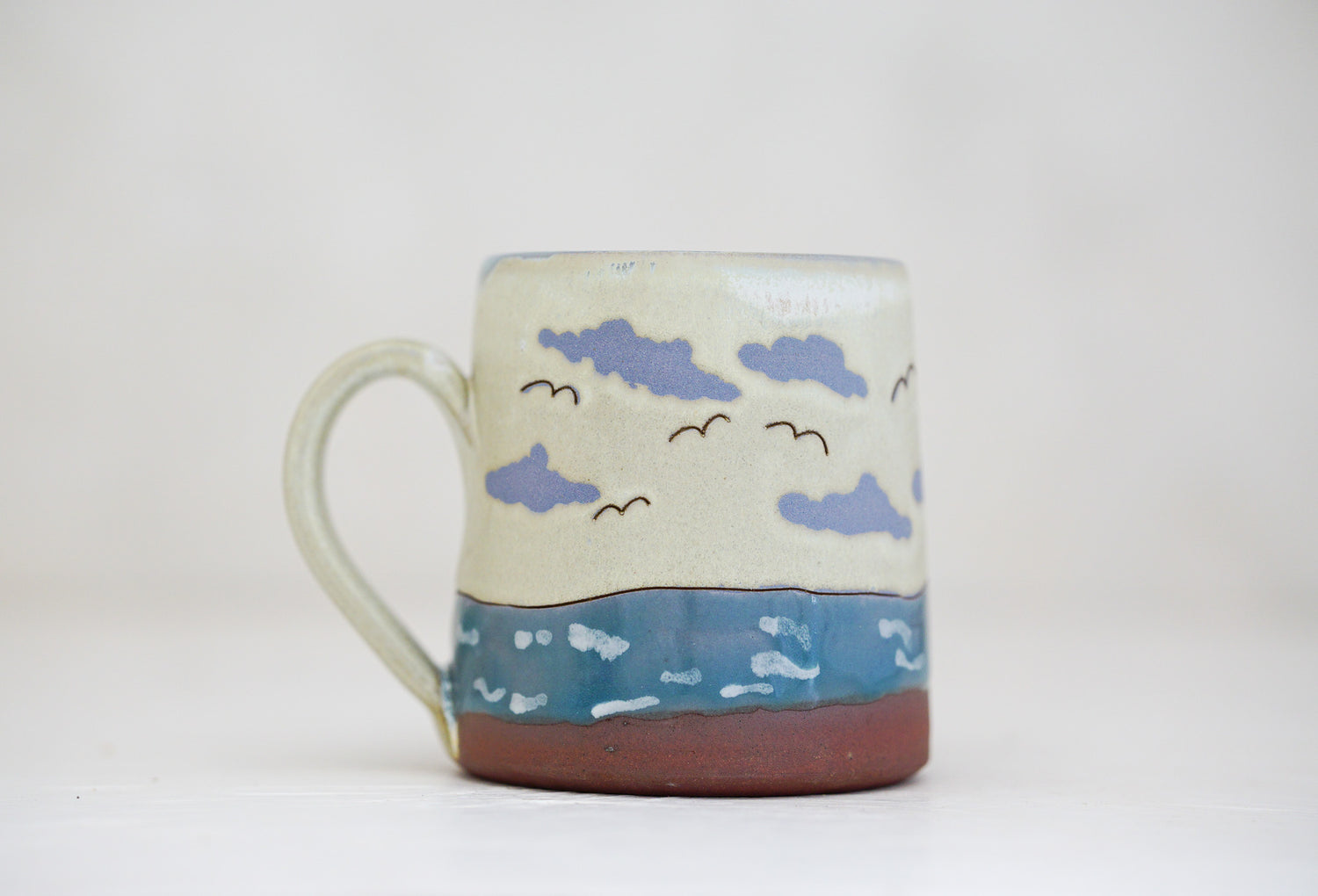 Waves roll in mug in Bone