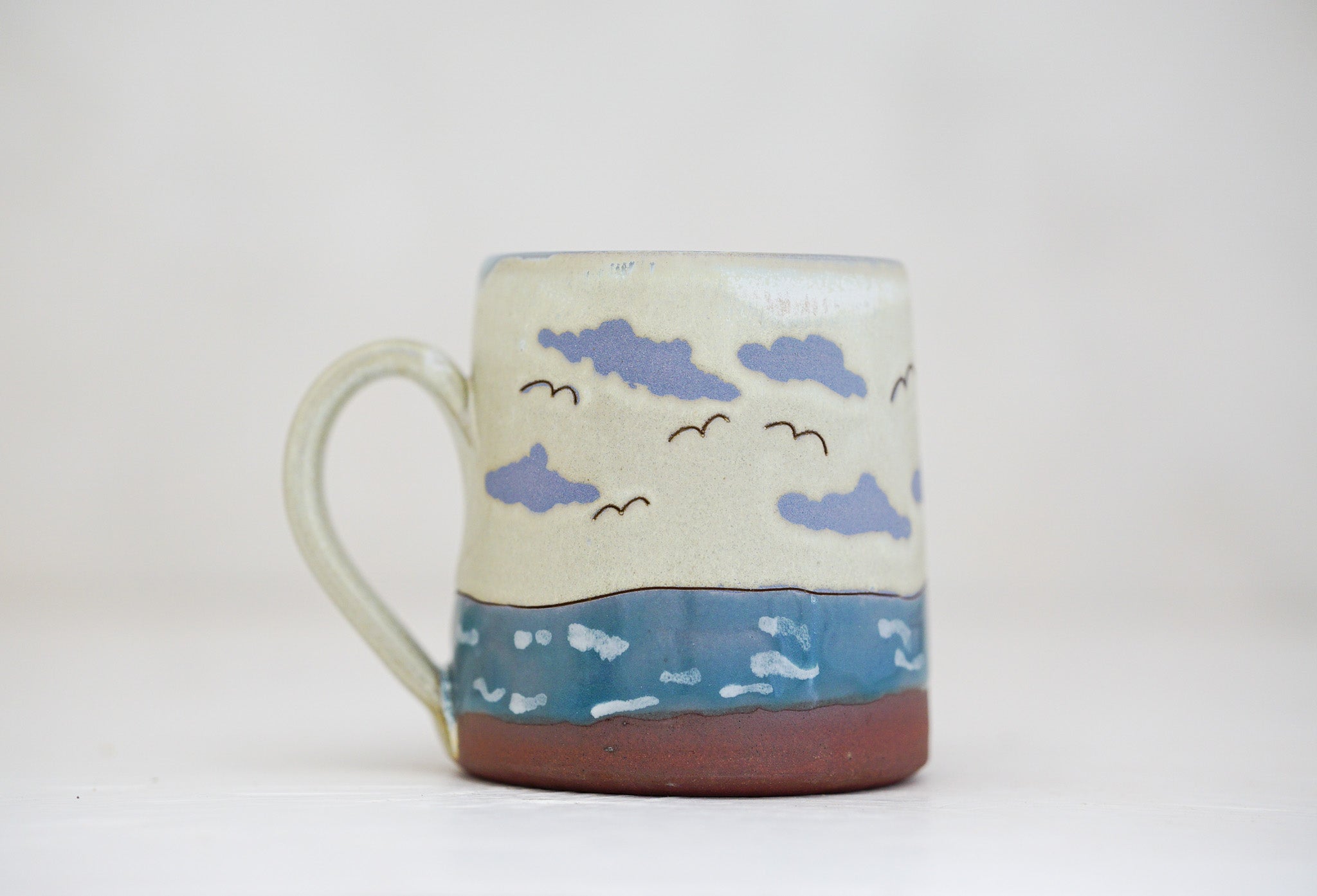 Waves roll in mug in Bone