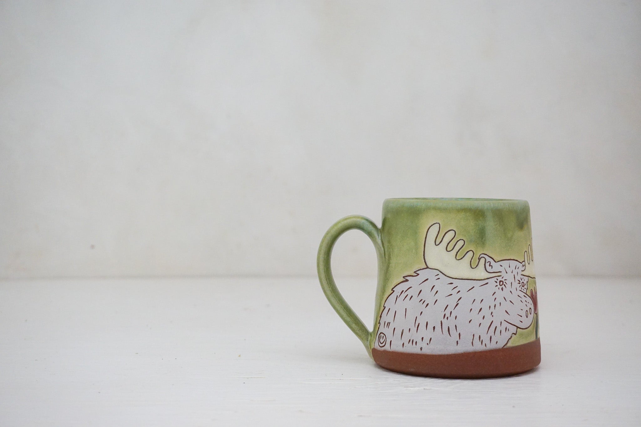 Moose smelling Flowers mug in Sage