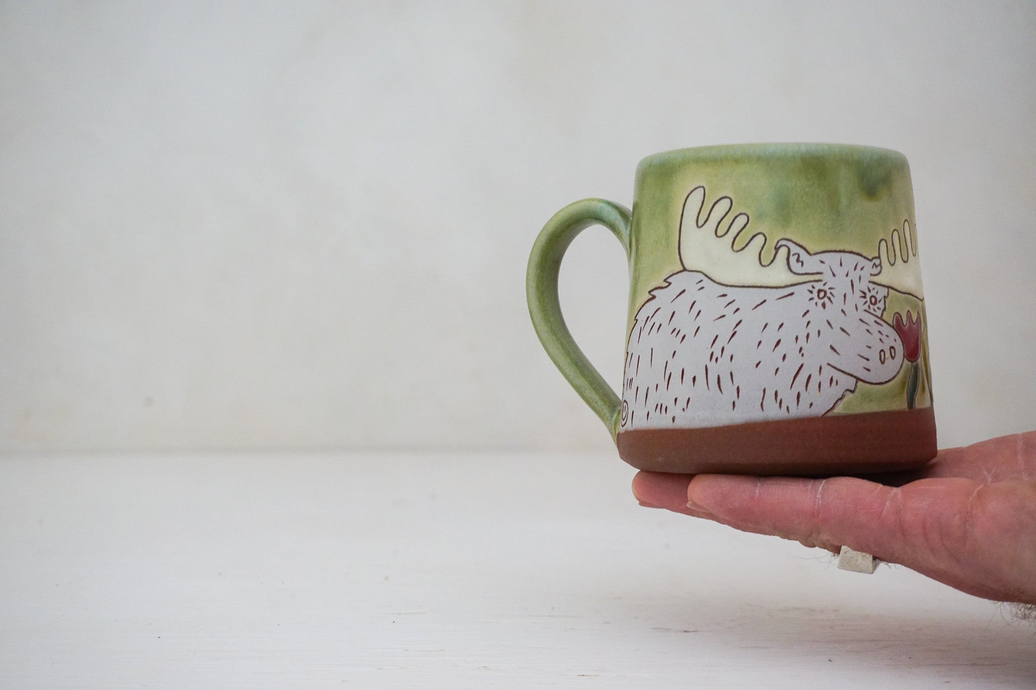 Moose smelling Flowers mug in Sage